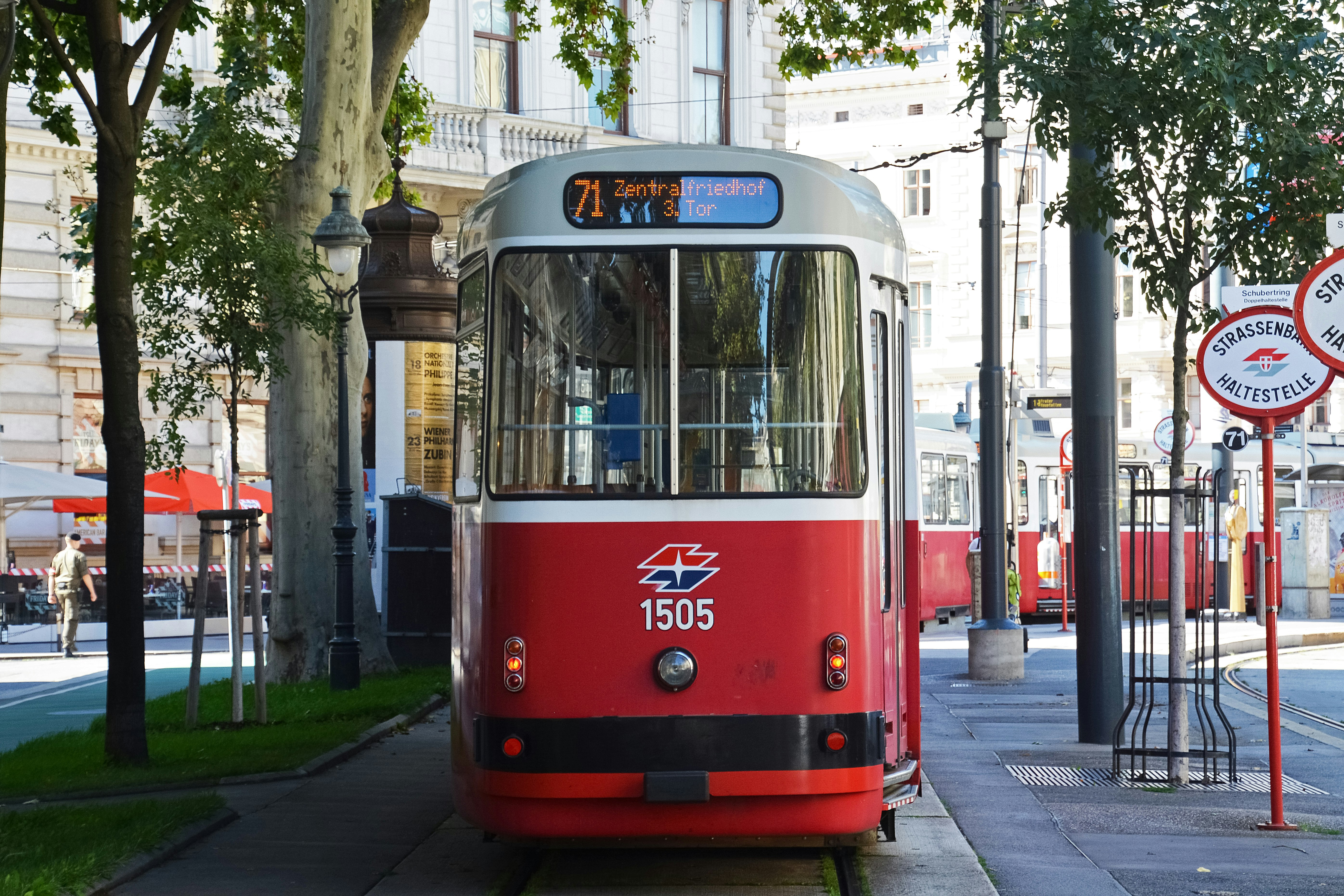 red and white tram on road during daytime